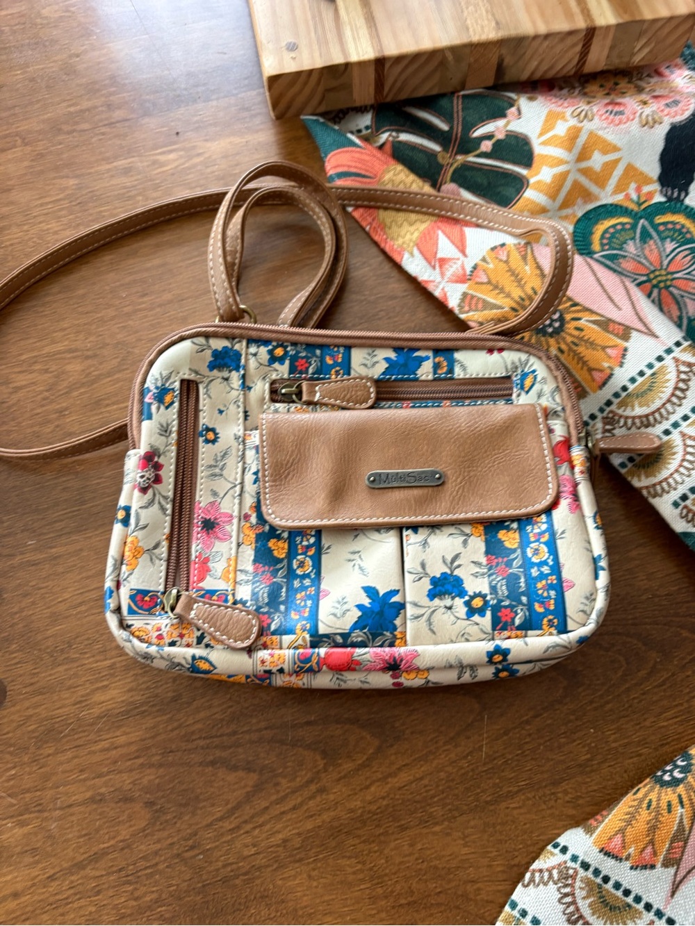 Floral crossbody bag with brown leather accents